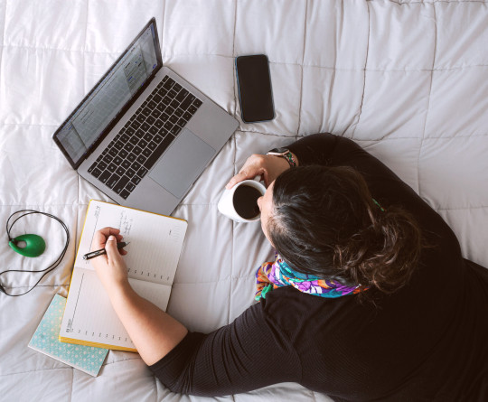 Woman on bed with laptop