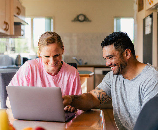 Couple at home on laptop
