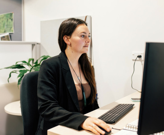 Woman at desk using computer